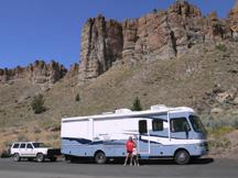 Kyle and Diana next to motorhome with Palisades Cliffs in background